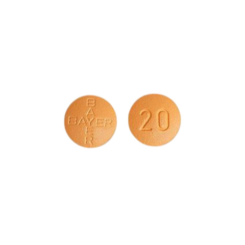 Close-up of round orange Levitra 20mg tablets, one side embossed with “20”