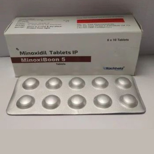 Minoxiboon 5 box and blister pack laid flat, packaging text and tablets legible