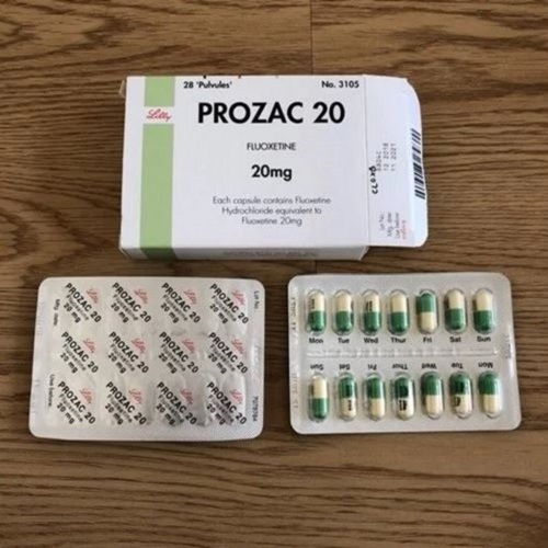Prozac 20mg (Fluoxetine) set of blister packs and outer box placed together on wooden surface