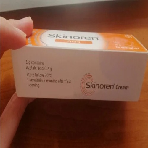 Skinoren Cream 20% product held in hand, showing external box labeling